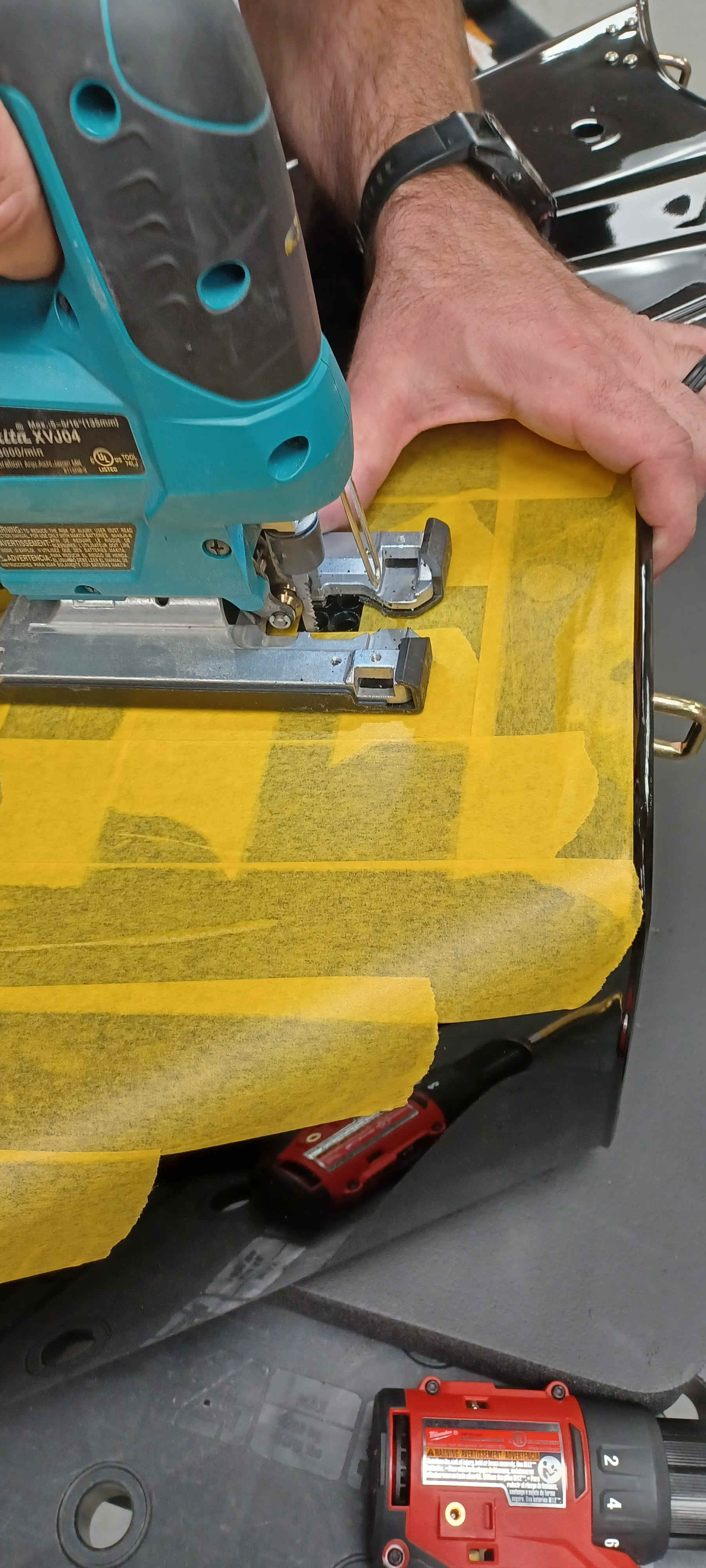 Bag masked and being cut with a jigsaw to form the plug opening